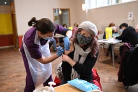 Doctor Kate Martin (L) administers an injection of AstraZeneca/Oxford Covid-19 vaccine to a patient at the vaccination centre set up at St Columba's church in Sheffield. (Photo by Oli SCARFF / AFP) (Photo by OLI SCARFF/AFP via Getty Images)