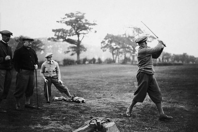 Arsenal defender Tom Parker takes a swing during a team training day at a golf course in Hatch End, 14th November 1929. Team-mate David Jack, manager Herbert Chapman and Alex James look on. Arsenal finished the season 14th in the league.