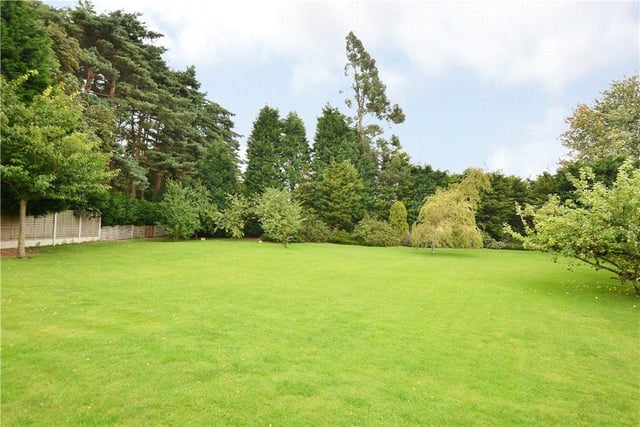 The grounds of the property extend to approximately 1.2 acres, with an extensive paved patio area and lawns, along with a variety of mature trees, shrubs and hedges.