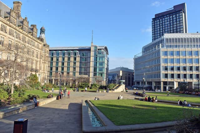 Sheffield City Centre. A few people out enjoying the sun in Sheffield Peace Gardens.