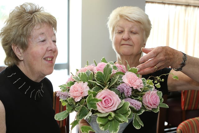 Chesterfield Flower Lovers Club diamond anniversary, vice chair Sandra Parker admires the work of Pat Billing who was the guest demonstrator in 2016