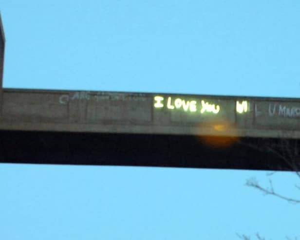 Neon 'I Love You Will U Marry Me' graffiti at Park hill Flats.