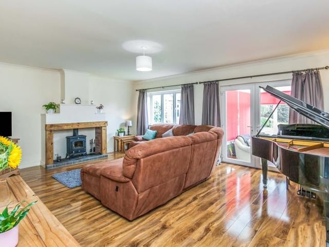 It would be impossible not to relax with your feet up in this lovely lounge. One of its main features is the fireplace with a multi-fuel stove fire, wood surround and tiled hearth, while double-glazed French doors lead into the conservatory.