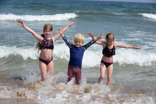 Youngsters Imogen, eight, Oscar, five, and Isabella, four, Benthan, enjoying a dip in the sea at Sandhaven Beach.