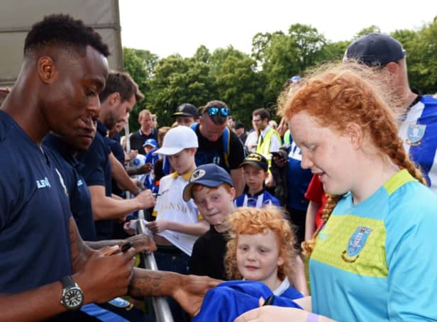 Sheffield Wednesday defender Moses Odubajo signs a fan's shirt at the 2019 Owls in the Park event.