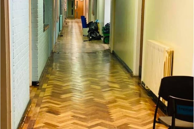 The attractive wood block patterned corridor remains in good condition.