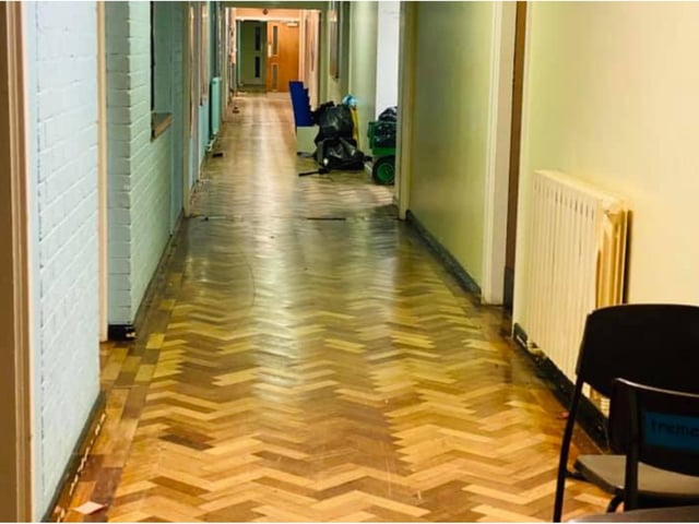 The attractive wood block patterned corridor remains in good condition.