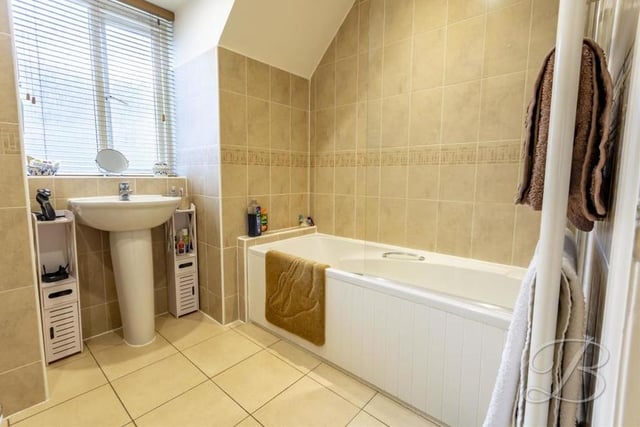 Like all the rooms in the £395,000 Mansfield home, the family bathroom is presented to a high standard. It comprises a panelled bath, chrome 'waterfall' shower, pedestal sink, low-flush WC and window to the side.