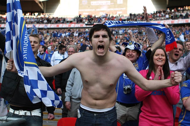 A Pompey fan celebrates his side's win over Spurs.