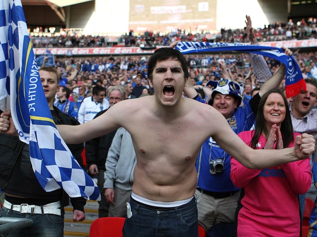 A Pompey fan celebrates his side's win over Spurs.
