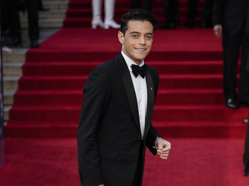 Rami Malek who is playing 007's nemesis poses for photographers upon arrival.