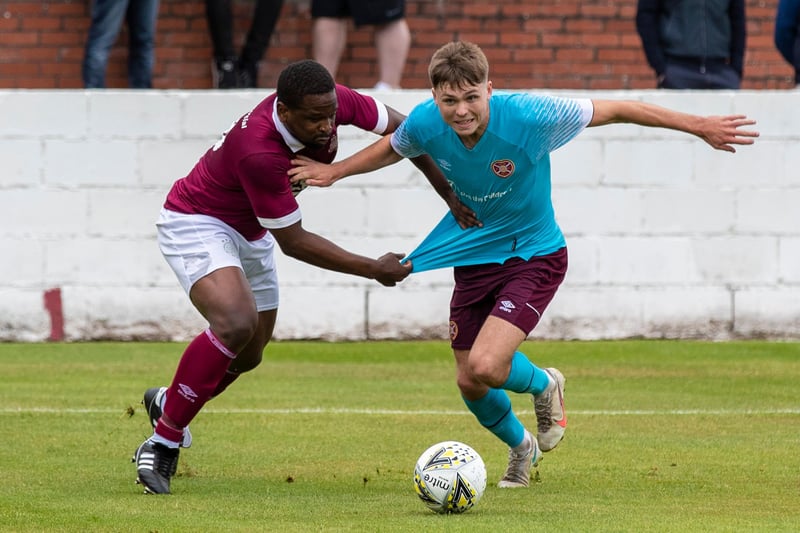 Linlithgow's Arnie Kasa (left) grapples with Hearts youngster Connor Smith