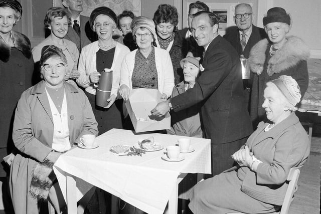 Councillor Peter Heatty draws winning ticket in Christmas prize draw at the Society of Leith Progressive Association's festive coffee morning in Leith Town Hall in 1962.