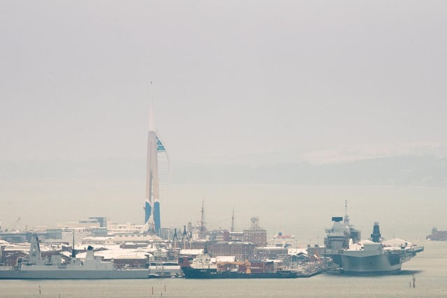 HMS Queen Elizabeth and the Spinnaker Tower surrounded by snow. Picture: Keith Woodland
