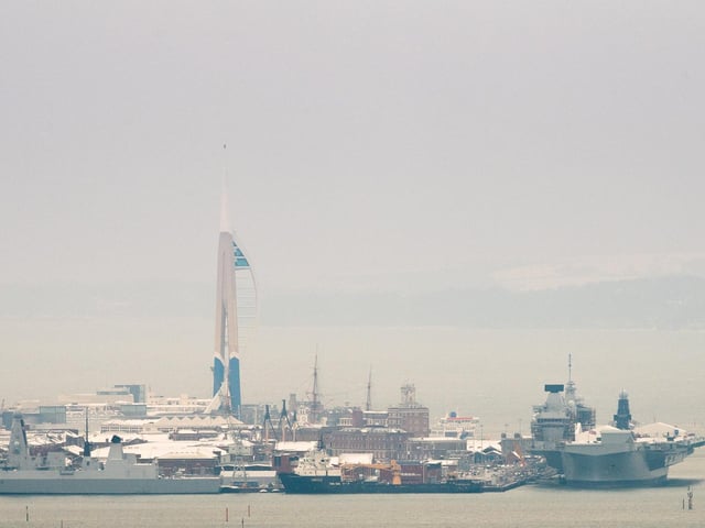 HMS Queen Elizabeth and the Spinnaker Tower surrounded by snow. Picture: Keith Woodland