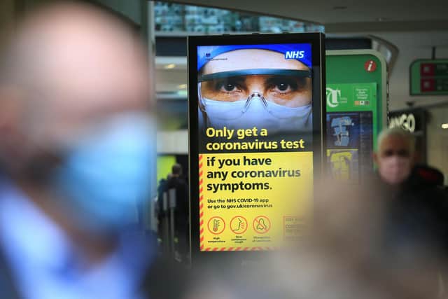 A digital display shows NHS health advice on the coronavirus displayed on October 30.  Photo by LINDSEY PARNABY/AFP via Getty Images