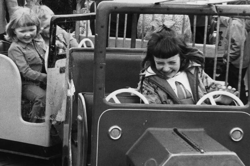 Look at the joy on the faces of these children as they enjoy the fairground 45 years ago.