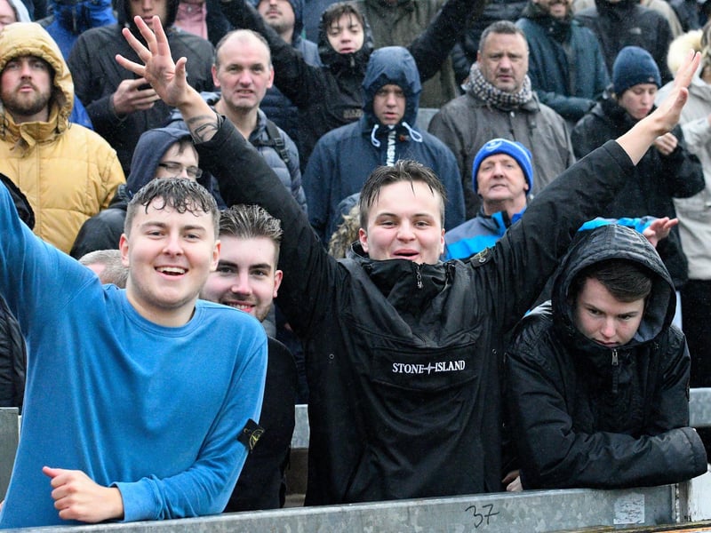 Rain-soaked supporters at Bristol Rovers during the 2019-20 season.