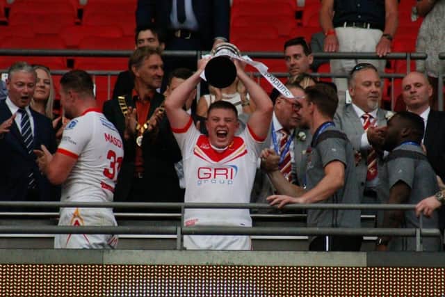 Blake Broadbent, the son of 1998 captain Paul, lifts the 1895 Cup after the Eagles' 36-18 victory over Widnes.