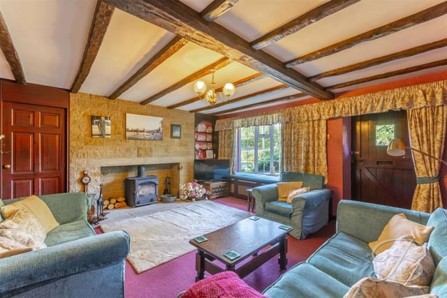 This lovely living room is the hub of the property. Giving a warm, homely feel, it includes exposed beams, a feature fireplace with brick surround, a carpeted floor and a bay window to the front.