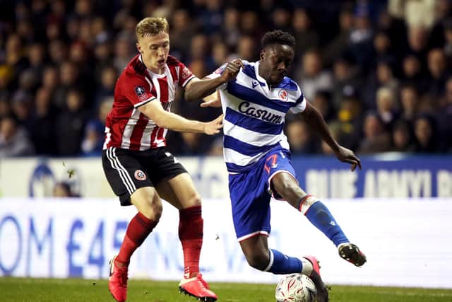 Reading's Andy Yiadom (right) and Sheffield United's Ben Osborn battle for the ball during the FA Cup fifth round match at the Madejski Stadium: Nick Potts/PA Wire.