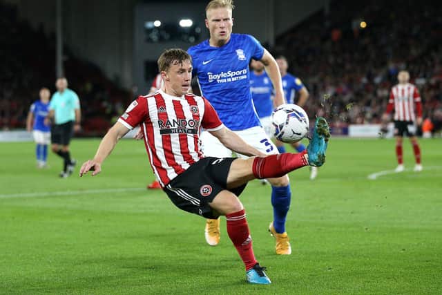 Sheffield United's Ben Osborn (left) and Birmingham City's Kristian Pedersen battle for the ball during the Sky Bet Championship match at Bramall Lane (pic: Nigel French/PA Wire)