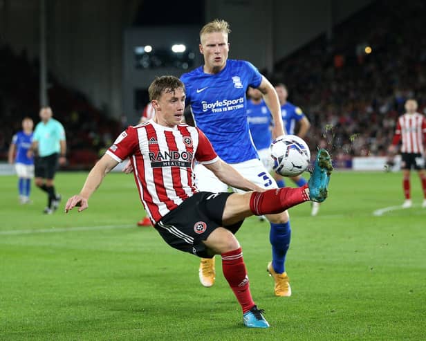 Sheffield United's Ben Osborn (left) and Birmingham City's Kristian Pedersen battle for the ball during the Sky Bet Championship match at Bramall Lane (pic: Nigel French/PA Wire)