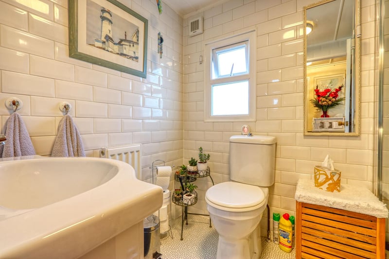 The family bathroom on the first floor has a four-piece suite with a shower over the bath.