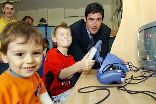 Pools manager Mike Newell is pictured opening the new Owton Fens Resource Stop Shop in 2003 and there were plenty of helpers on the big day.