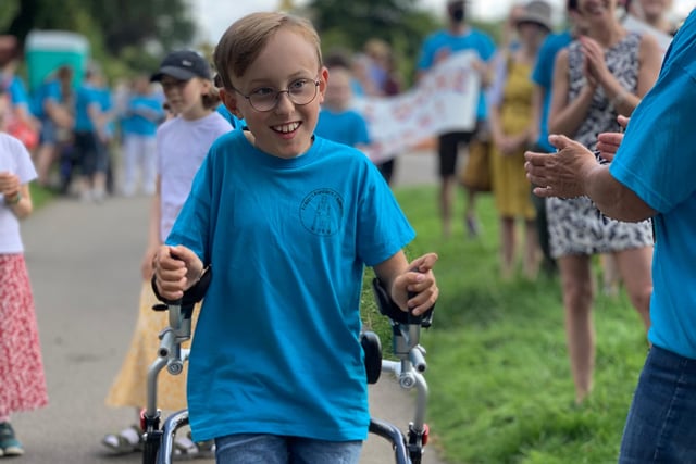 As well as hundreds of supporters, Tobias walked every step of his final stretch flanked by mum Ruth and Olympic champion Jessica Ennis, who raced him to the finish line