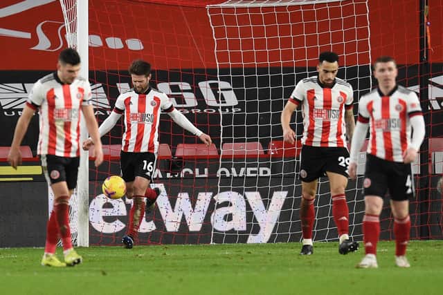 SHEFFIELD, ENGLAND - FEBRUARY 07: Ollie Norwood of Sheffield United looks dejected with team mates after Chelsea's first goal scored by Mason Mount (Not pictured) during the Premier League match between Sheffield United and Chelsea at Bramall Lane on February 07, 2021 in Sheffield, England. Sporting stadiums around the UK remain under strict restrictions due to the Coronavirus Pandemic as Government social distancing laws prohibit fans inside venues resulting in games being played behind closed doors. (Photo by Oli Scarff - Pool/Getty Images)