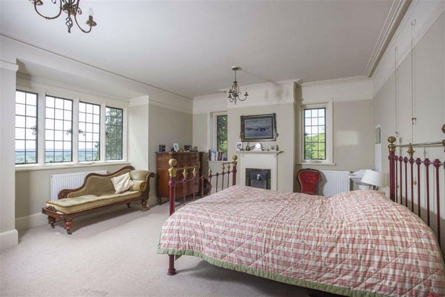 There are six bedrooms throughout the property, with this large double room featuring an open fire place and a mullion bay window which offers superb countryside views.