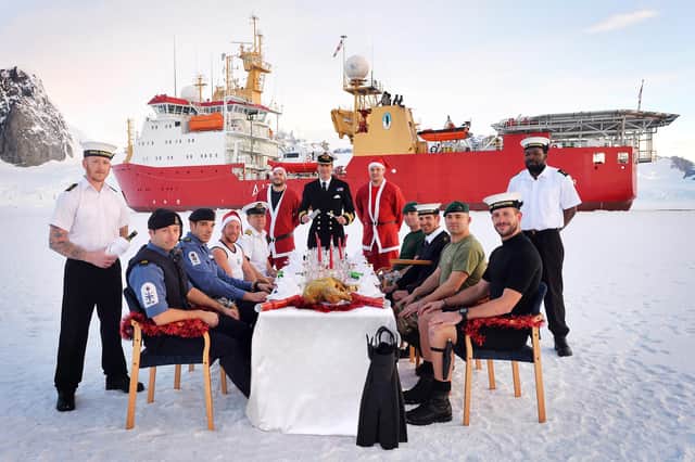 HMS Protector's crew tucking into their Christmas meal during a trip to the Antarctic in 2013. Pictured left to right: LSTD Chapman, PO(AWW) McDonald, PO(CS) Spencer, LPT Smith, 1Lt Varty, CH Naun, Captain Hatcher (CO), AB(SEA) Scott, Sgt Smith, LS(AWW) Kendall, LCPL Brunning, LSD Chudley, LSTD Dickson. *** Local Caption *** L-R: LSTD Chapman, PO(AWW) McDonald, PO(CS) Spencer, LPT Smith, 1Lt Varty, CH Naun, Captain Hatcher (CO), AB(SEA) Scott, Sgt Smith, LS(AWW) Kendall, LCPL Brunning, LSD Chudley, LSTD Dickson.