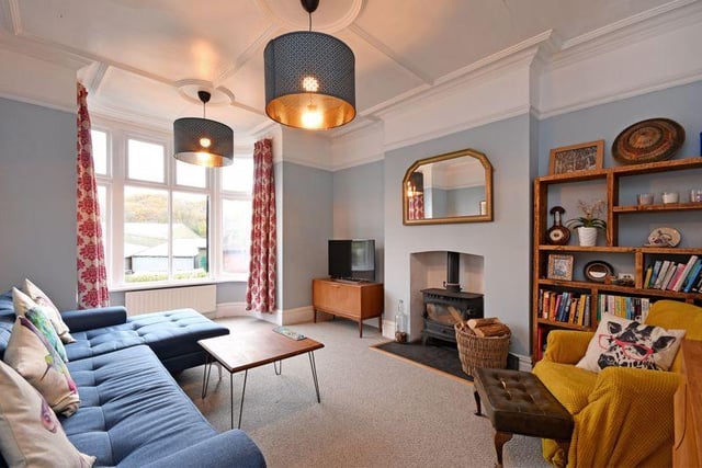 The large front lounge has a double-glazed bay window and a log burner that provides a focal point for the room.