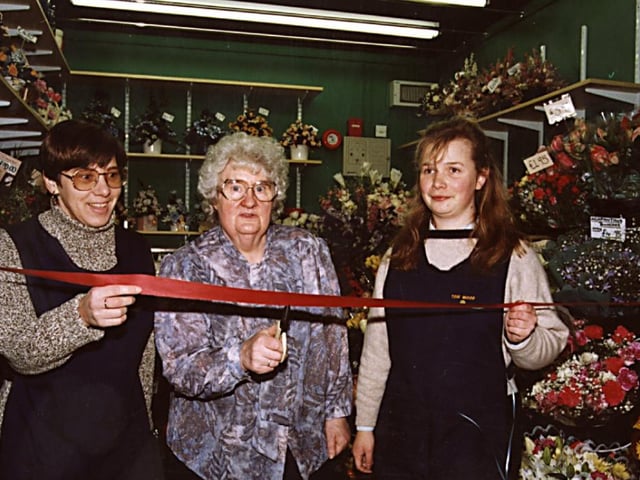 The official opening of  Tom Woods in the Frenchgate Centre in  1996, Jeanette Fish cut the ribbon watched on by  Anne Molloy and  Julie Higham