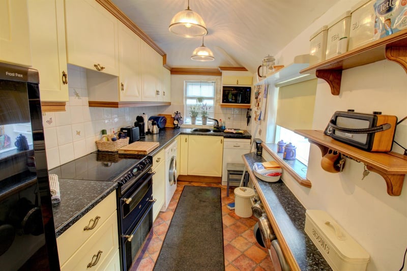 The kitchen has two windows looking through into the ‘sun/conservatory’ porch as well as a window overlooking the street. It is fitted with a range of wall and base units and has space for a free-standing cooker and fridge freezer.