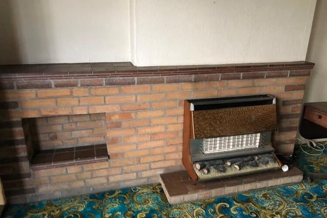 A gas fire with brick surround in the sitting room
