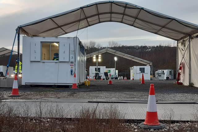 The windswept site has several large drive-through tents with a portacabin for staff.