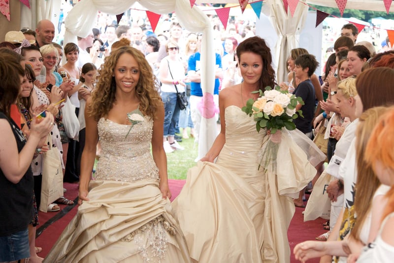 Brides Bella Parker and Lorna Grey walk down the aisle for their wedding blessing at Sheffield Pride 2010
