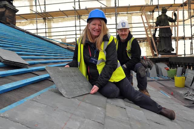 Sponsored Make Your Mark In History slates go on the East Front portico. House volunteer tour guide Ros Burnett is pictured with Martin Brooks roofer Dean Feethan