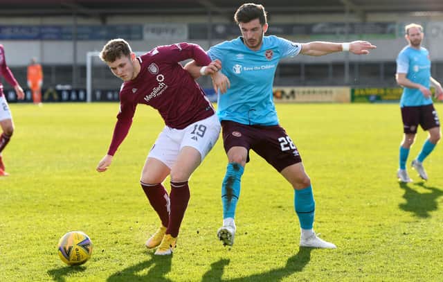 ARBROATH, SCOTLAND - MARCH 20: Arbroath's Jack Hamilton and Hearts' Mihai Popescu in action during the Scottish Championship match between Arbroath and Heart of Midlothian at Gayfield Park on March 20, 2021, in Arbroath, Scotland. (Photo by Sammy Turner / SNS Group)