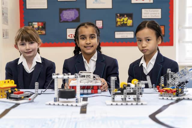Abby Billups , Maya Gupta and Tiffany Kuoh celebrate Sheffield Girls' Junior School being chosen as the first national robotic s hub for primary school children