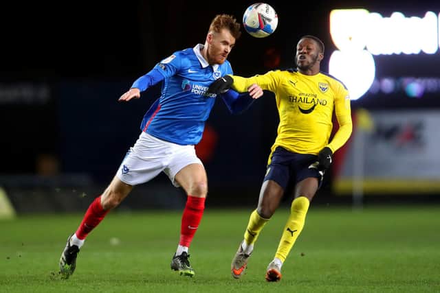 Portsmouth's Tom Naylor (left) and Oxford United's Olamide Shodipo battle for the ball during the Sky Bet League One match at Kassam Stadium, Oxford. Picture date: Tuesday February 23, 2021. PA Photo. See PA story SOCCER Oxford. Photo credit should read: David Davies/PA Wire.
