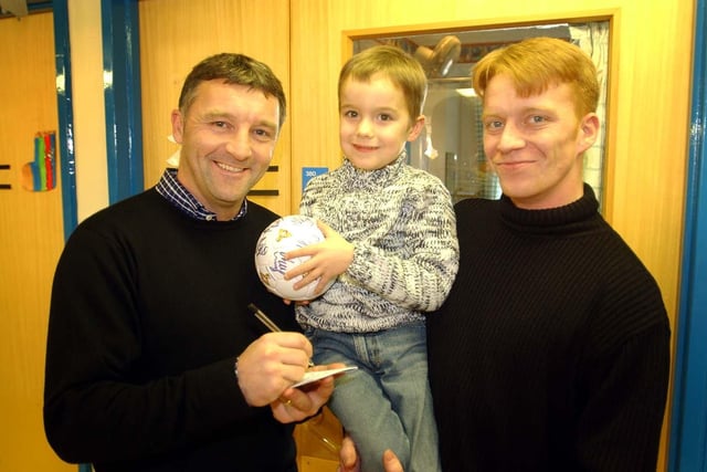 Rovers manager Dave Penney signs an autograph for five-year-old Nathan Brookes and his dad Lee from Scawsby during the DRI visit in Christmas 2003.