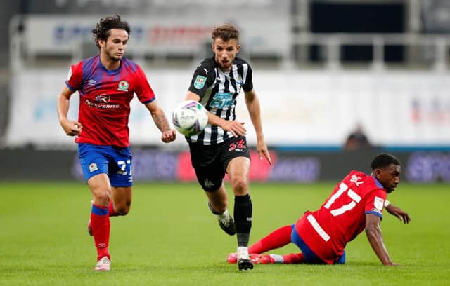 Dan Barlaser of Newcastle United battles for possession with Lewis Travis and Amari'i Bell of Blackburn Rovers during the Carabao Cup Second Round match between Newcastle United and Blackburn Rovers at St. James Park on September 15, 2020 in Newcastle upon Tyne, England. (Photo by Lee Smith - Pool/Getty Images)