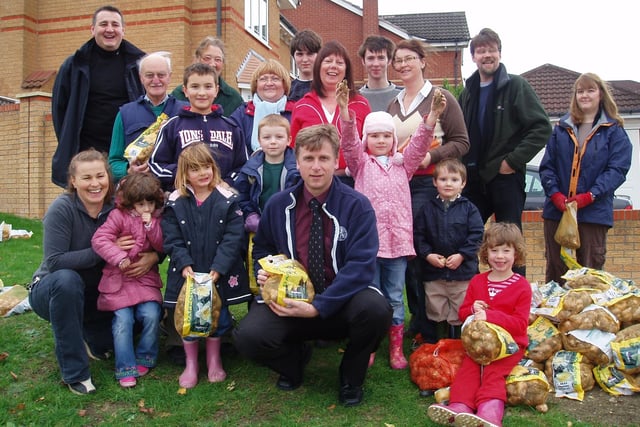 Friends of Barlborough in Bloom volunteers and supporters including parish councillor  Bridget Ingle (left, front row) and Dobbies Garden World manager Brian Parker (centre front row) during the village's Marie Curie Field of Hope daffodil planting project in 2007.