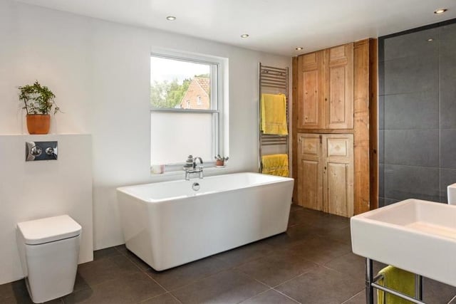 The Southwell property boasts four bathrooms, two of which are en suite to bedrooms. This is the sizeable family bathroom, complete with a free-standing bath with central mixer tap, and a low-level WC. A cupboard houses the gas combination boiler.