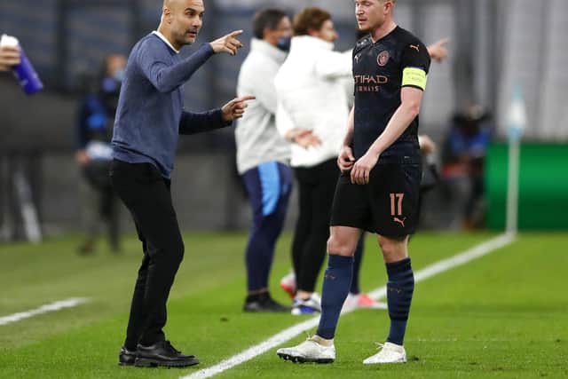 Manchester City's head coach Pep Guardiola, left, gestures as he talks with Kevin De Bruyne, who Sander Berge believes is the best plater in the world right now:  Horcajuelo/Pool via AP