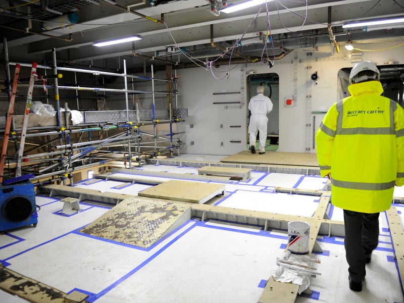 Workers at Babcock's, Rosyth shipyard, in Scotland, work to assemble the separate pieces of HMS Queen Elizabeth together in December 2012. Picture: Allan Hutchings (123920-279)