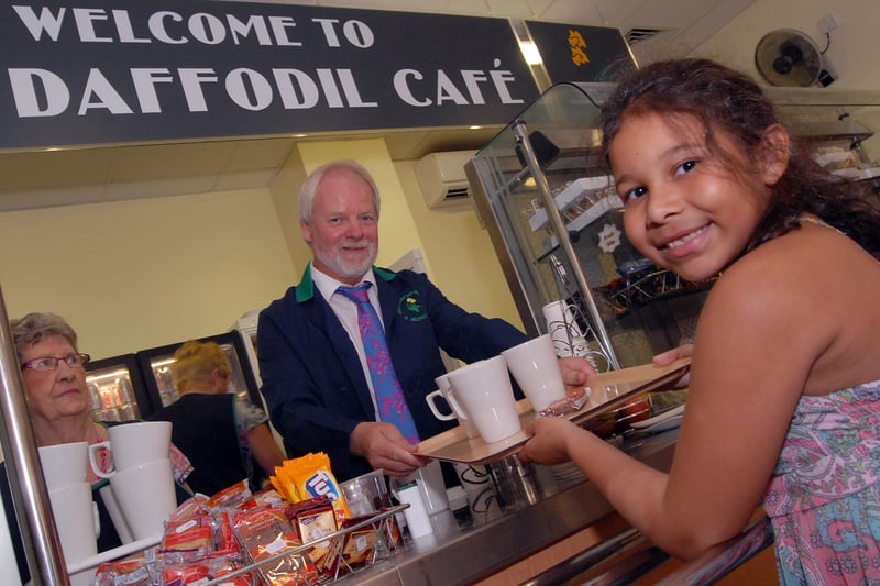 Nottinghamshire County Council chief executive Mick Burrows serves up tea to Daffodil Café customer Denisha Palin during a stint of volunteering at King's Mill Hospital in 2011.